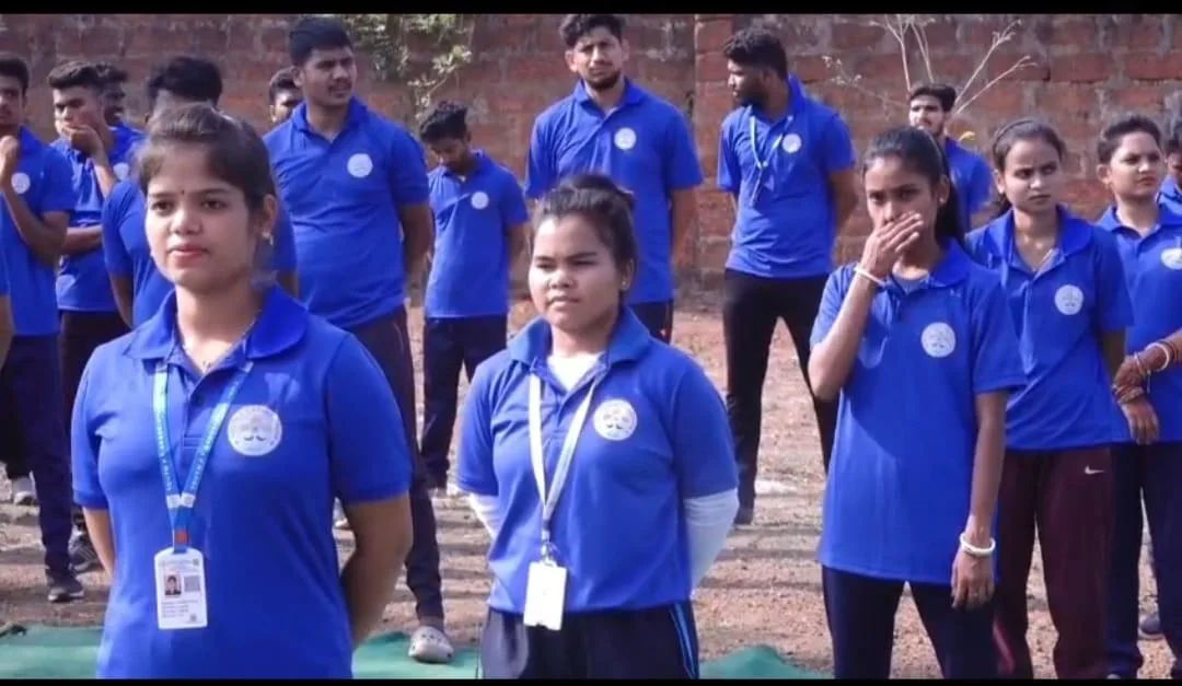 Students in blue association uniforms standing together outdoors.