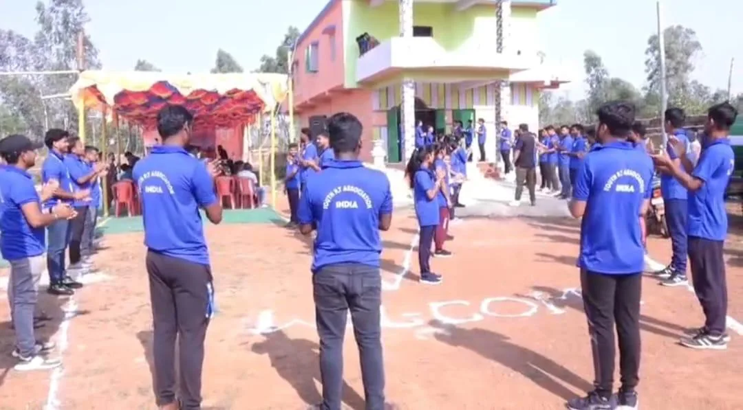 Youth participants forming lines during an outdoor campus activity.