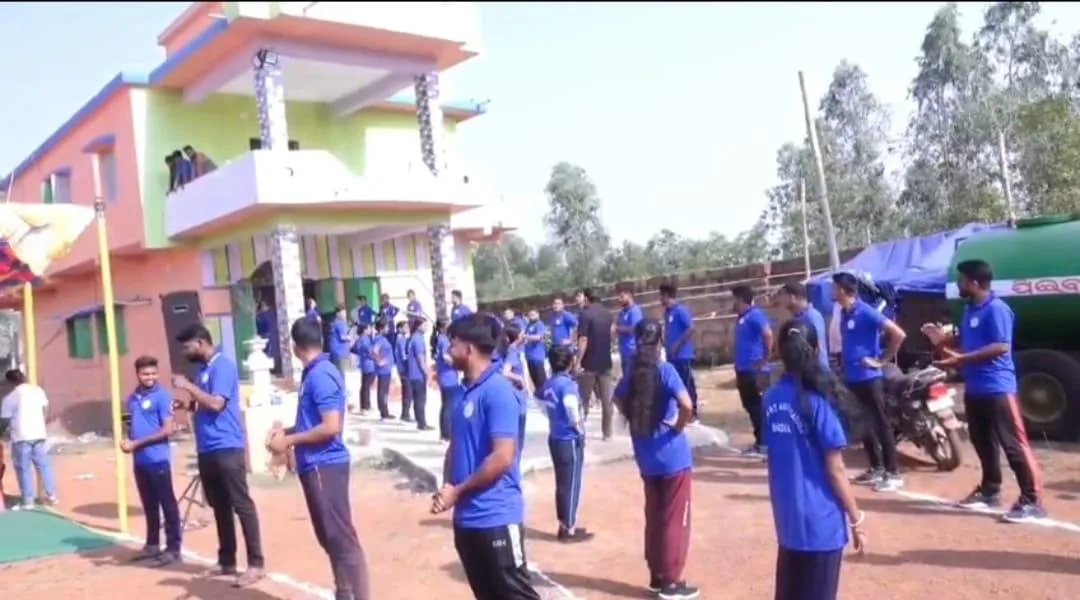 Students practising coordinated outdoor drill movements on a school campus.