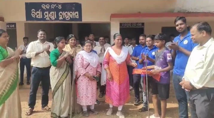 Students receiving awards from teachers and guests outside a school building.