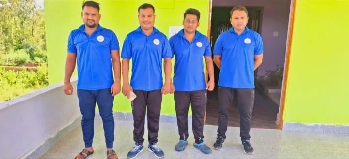 Association staff members in blue uniforms standing together.