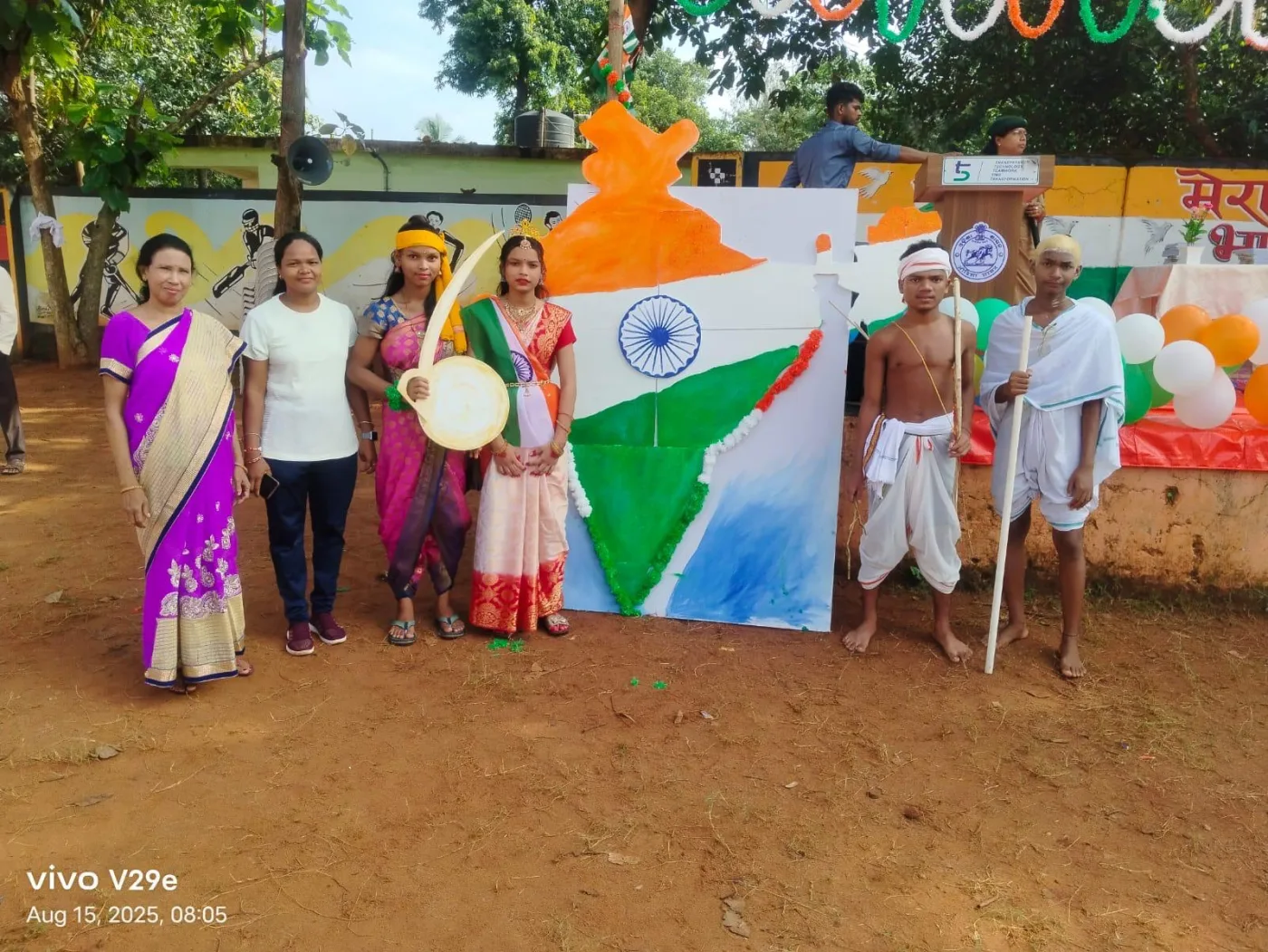 Students and teachers presenting a patriotic tableau with the Indian flag