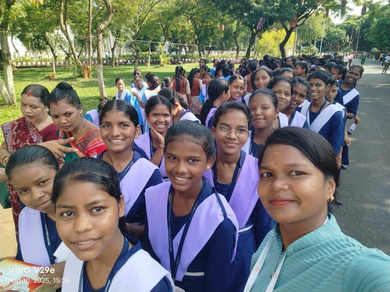 A large group of students smiling together outdoors.