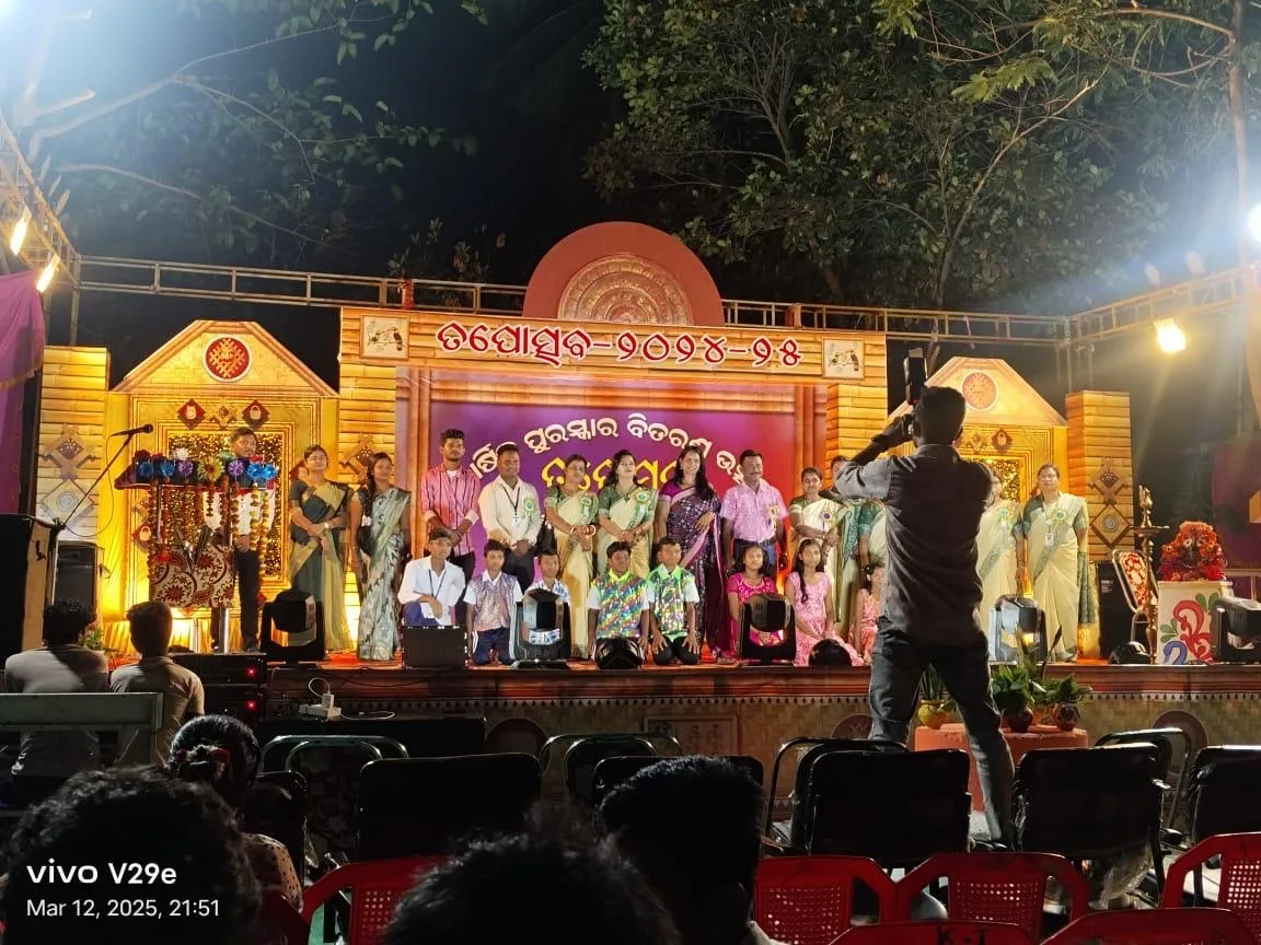 Students and guests on a decorated stage during an evening awards program