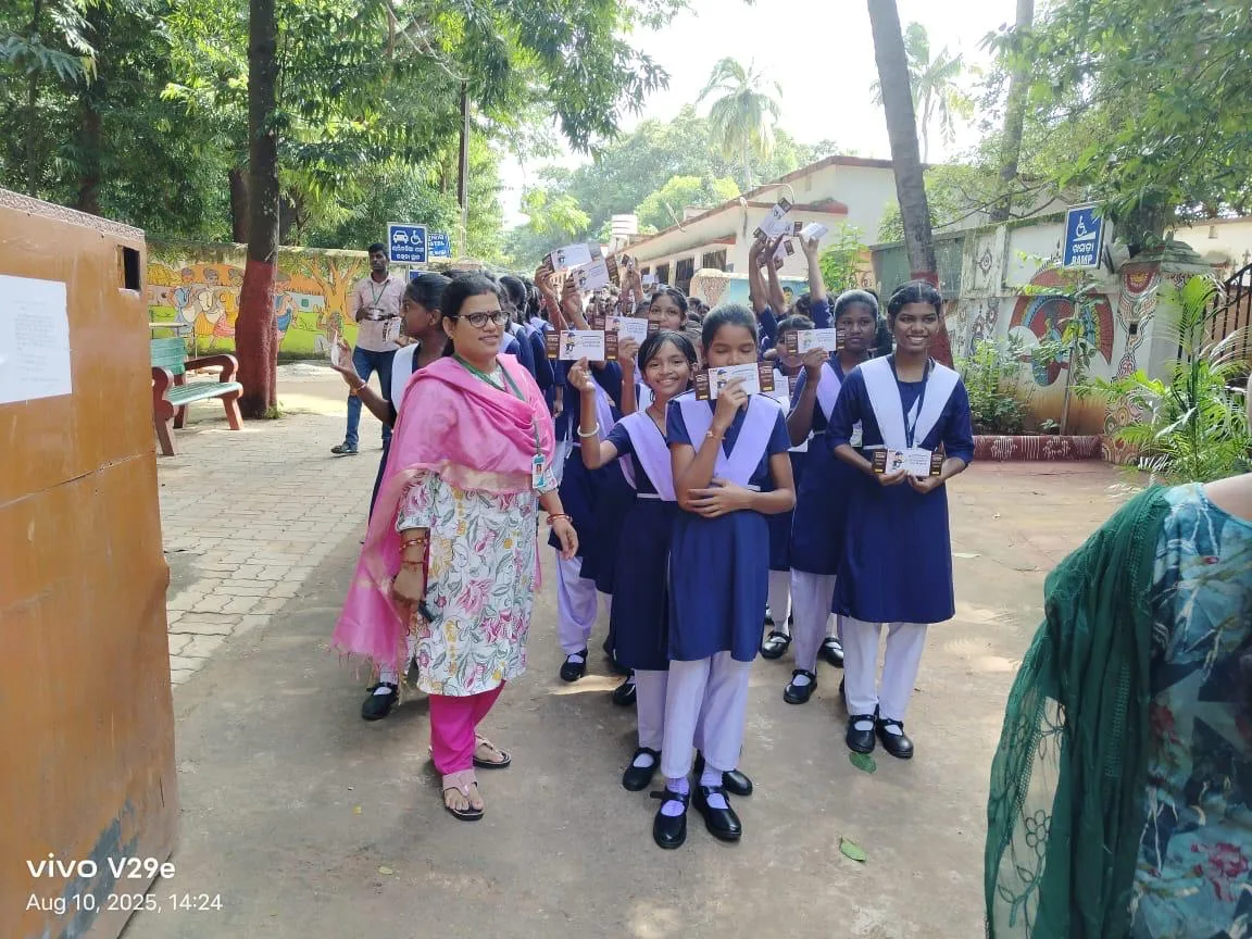 Students walking with a teacher after an outdoor school activity.