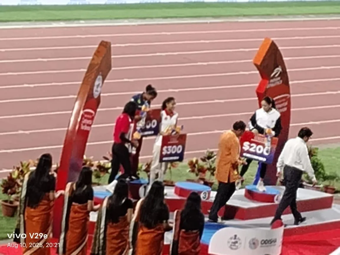 Young athletes lining up at the start of a track race.