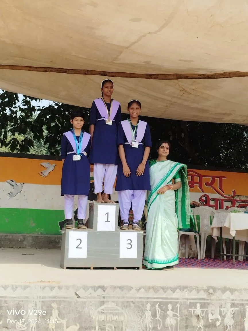 Students receiving awards on a winners podium at a school event.