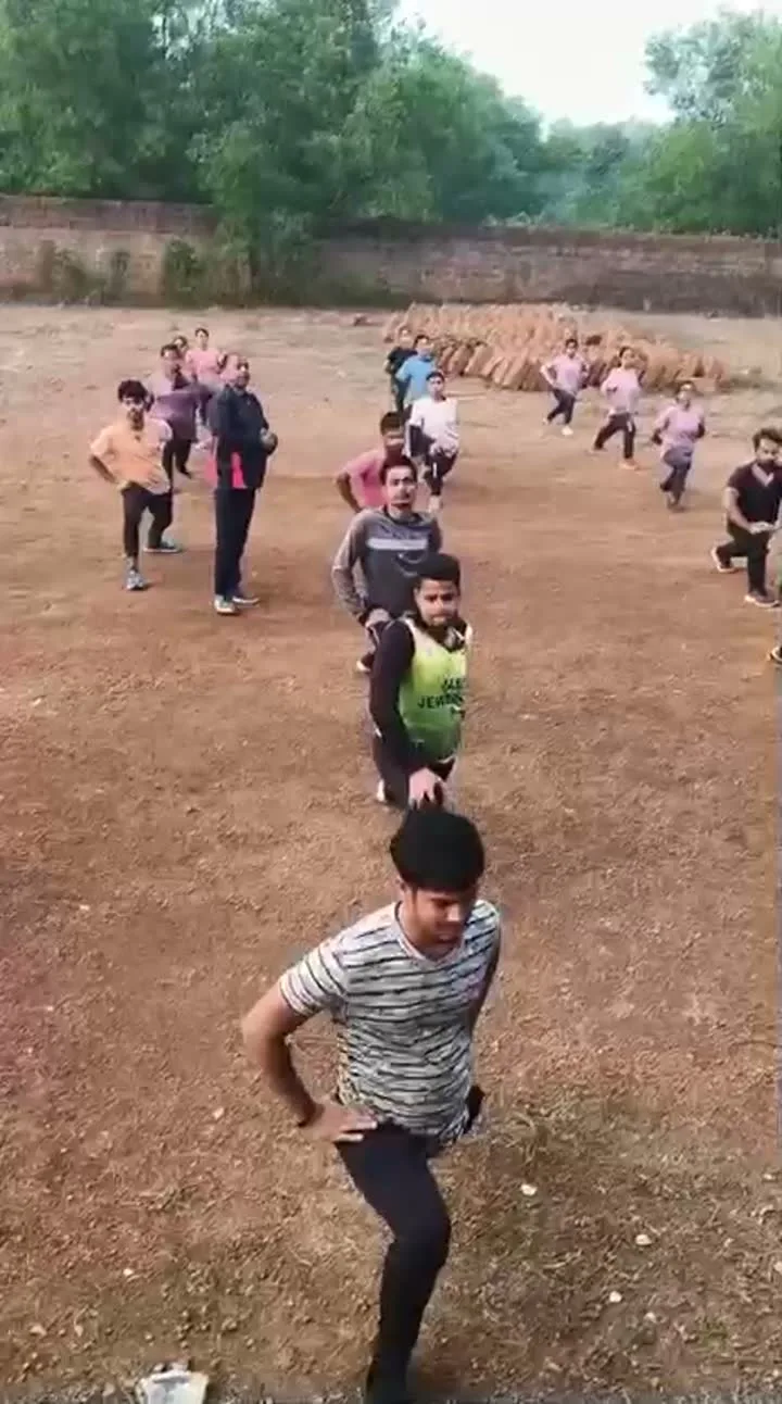 Students practising coordinated field drills during a school activity.