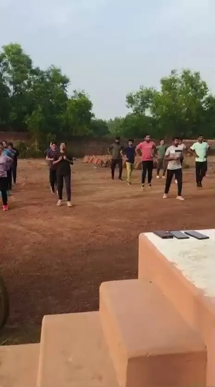 Students assembled on the ground for an outdoor activity session.